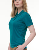 Woman wearing a teal polo shirt on a white background